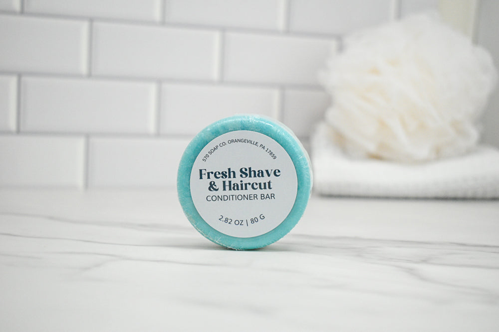 Conditioner bar labeled 'Fresh Shave & Haircut' on a bathroom counter.