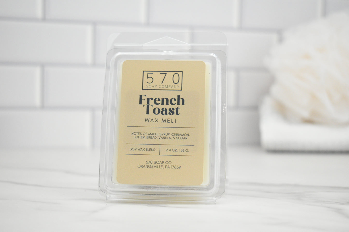 French Toast wax melt packaging on a white surface with a blurred background