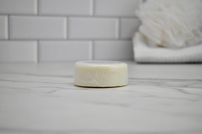 Bar of soap on a bathroom counter with tiled wall in the background