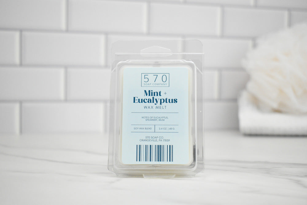 Wax melt packaging labeled '570 Mint Eucalyptus' on a white surface with a neutral background.