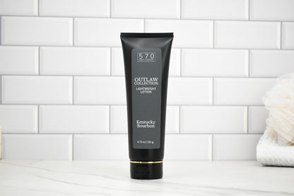 Black tube of Outlaw Collection 570 Kentucky Bourbon lighter fluid on a white tiled background