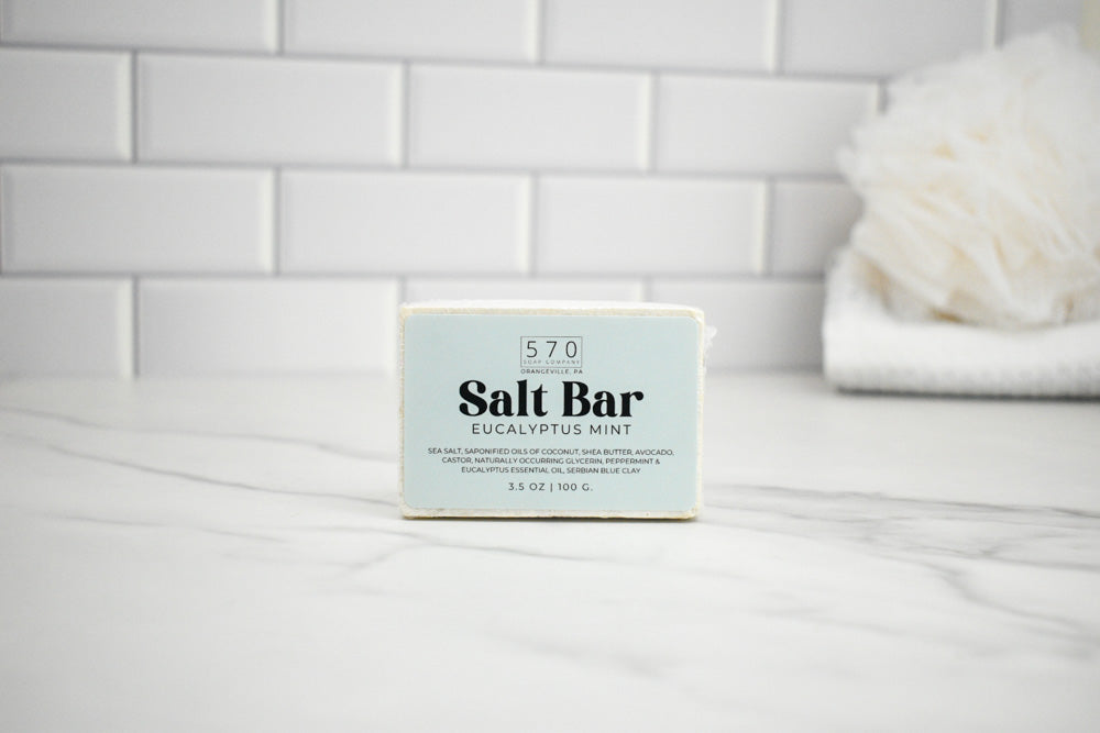 Salt bar with label on a white surface against a tiled wall background