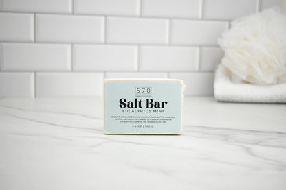 Salt bar with label on a white surface against a tiled wall background