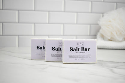 Three boxes of '570 Salt Bar Lavender' on a white surface with a tiled wall background.