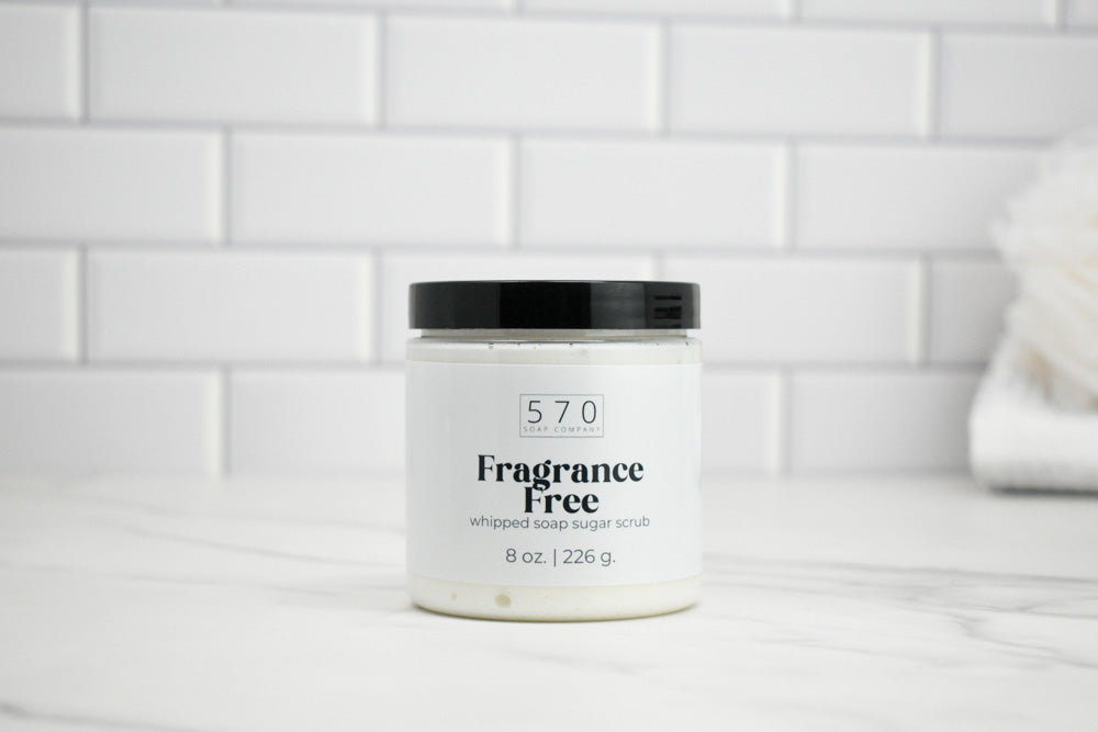Jar of 570 whipped soap sugar scrub labeled 'Fragrance Free' on a white tiled background