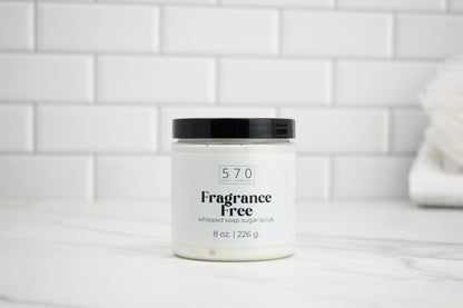 Jar of 570 whipped soap sugar scrub labeled 'Fragrance Free' on a white tiled background