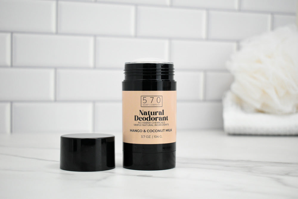 570 Natural Deodorant stick on a white surface with a tiled wall background