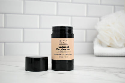 570 Natural Deodorant stick on a white surface with a tiled wall background