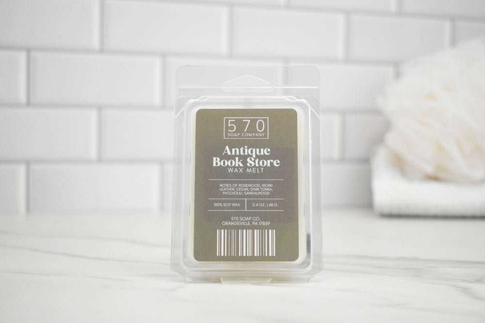 Wax melt packaging labeled '570 Antique Book Store' on a white tiled background