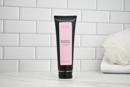 Tube of Strawberry Pound Cake Lotion on a white tiled background