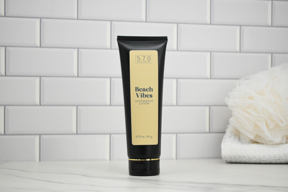 Tube of Beach Vibes lotion on a tiled bathroom shelf