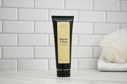 Tube of Beach Vibes lotion on a tiled bathroom shelf