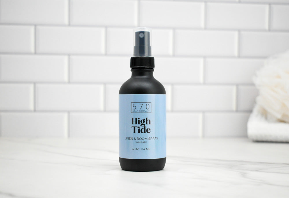 Bottle of 570 High Tide spray on a bathroom counter with tiled wall background