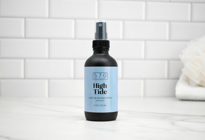 Bottle of 570 High Tide spray on a bathroom counter with tiled wall background