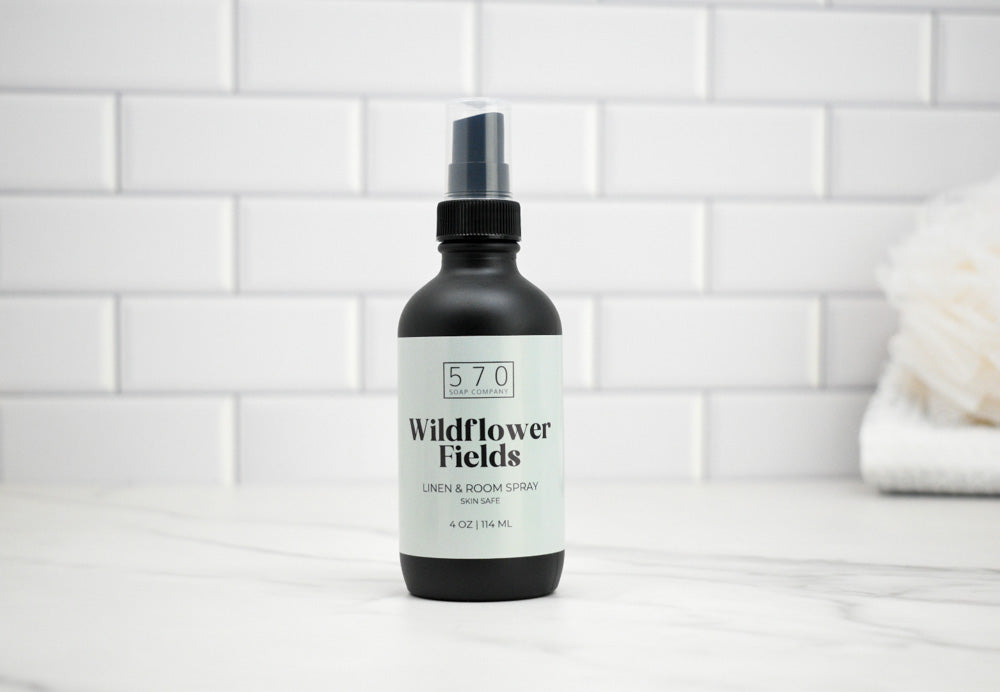 Black spray bottle labeled '570 Wildflower Fields' on a white tiled background