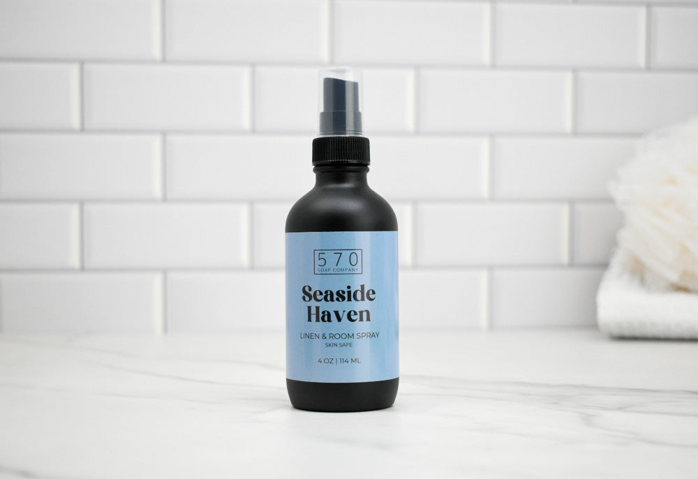Bottle of 'Seaside Haven' room spray on a tiled bathroom counter