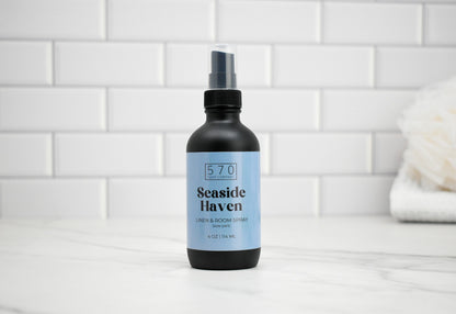 Bottle of 'Seaside Haven' room spray on a tiled bathroom counter