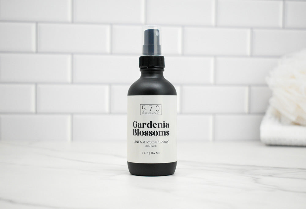 Bottle of 570 Gardenia Blossoms room spray on a white tiled background
