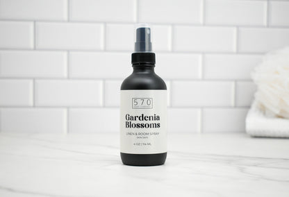 Bottle of 570 Gardenia Blossoms room spray on a white tiled background