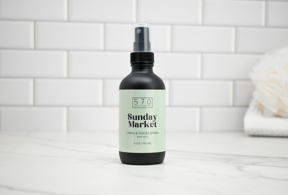 Bottle of '570 Sunday Market' product on a white tiled background