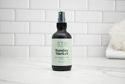 Bottle of '570 Sunday Market' product on a white tiled background