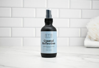 Bottle of 570 Coastal Reflection product on a white tiled bathroom shelf