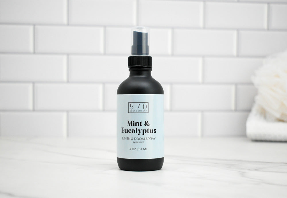 570 Mint & Eucalyptus linen and room spray bottle on a white tiled background