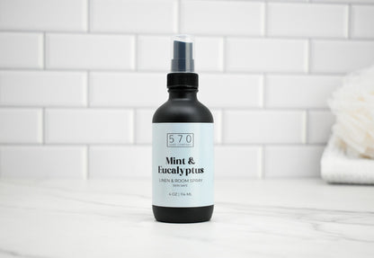 570 Mint & Eucalyptus linen and room spray bottle on a white tiled background