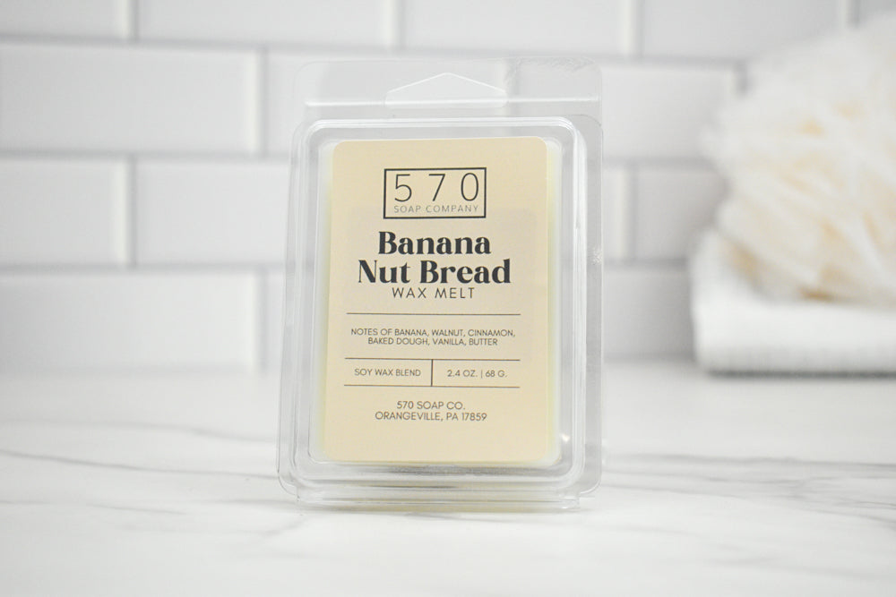 Banana Nut Bread wax melt packaging on a white surface with a neutral background