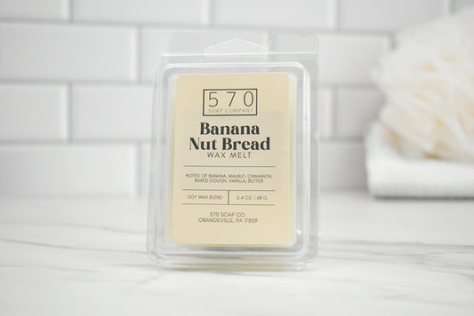 Banana Nut Bread wax melt packaging on a white surface with a neutral background