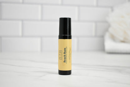 Skincare product bottle with black cap on a white surface with a tiled wall background