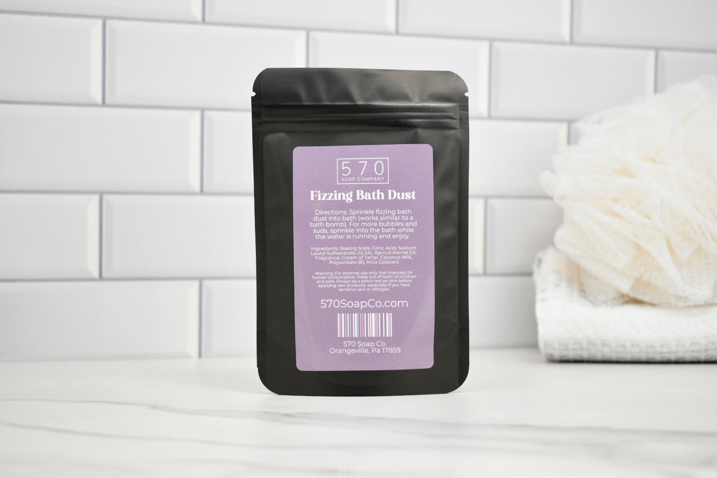 Packaged product labeled '570' on a white tiled bathroom wall.