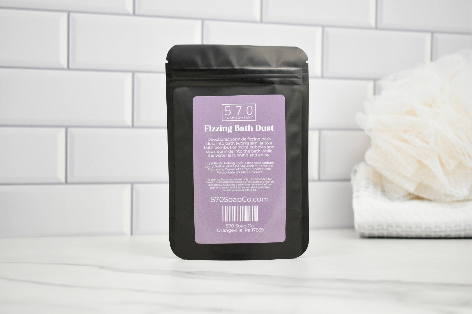 Packaged product labeled '570' on a white tiled bathroom wall.