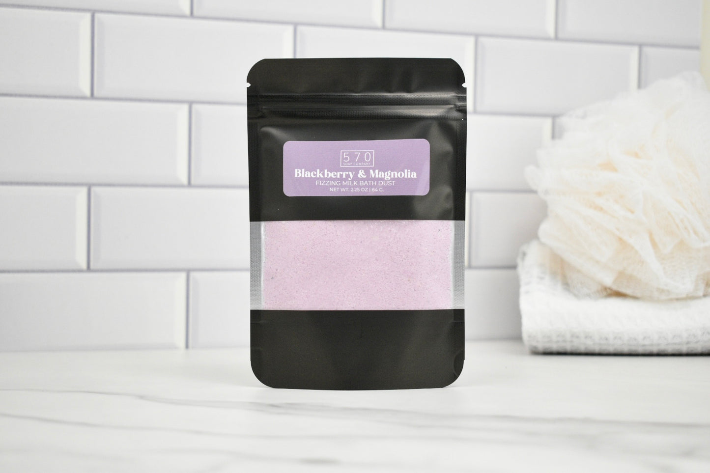 Black packaging with a purple label on a white surface