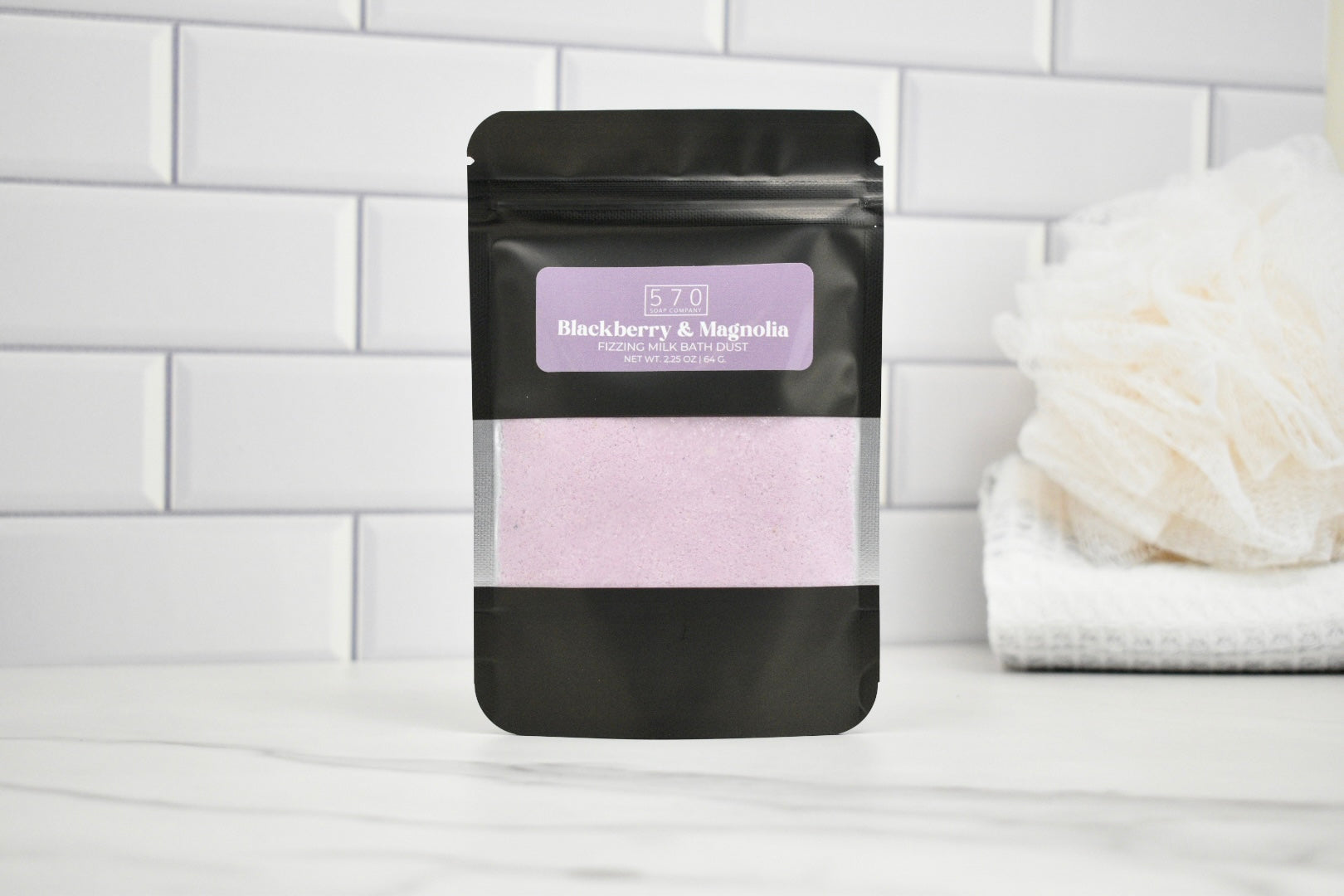 Black packaging with a purple label on a white surface