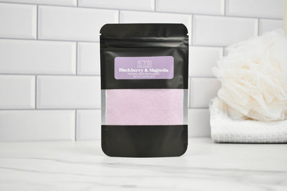 Black packaging with a purple label on a white surface