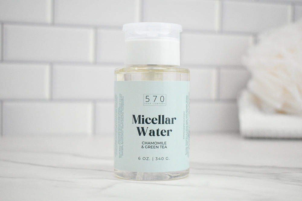 Bottle of 570 Micellar Water on a bathroom counter with a tiled wall background
