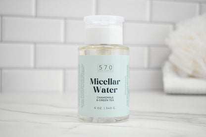 Bottle of 570 Micellar Water on a bathroom counter with a tiled wall background
