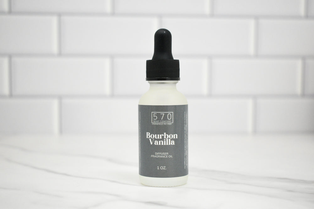 Bottle of Bourbon Vanilla fragrance oil with a dropper on a white tiled background