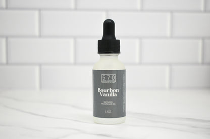 Bottle of Bourbon Vanilla fragrance oil with a dropper on a white tiled background