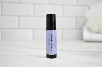 Roll-on bottle with purple label on a white surface with a tiled wall background