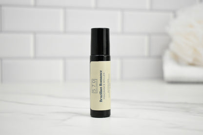 Skincare roller bottle on a white surface with a tiled wall background