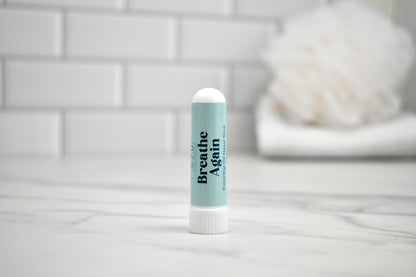 Nasal stick with 'Breathe Again' text on a bathroom counter