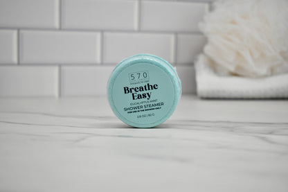 Breathe Easy shower steamer on a bathroom counter with a tiled wall background