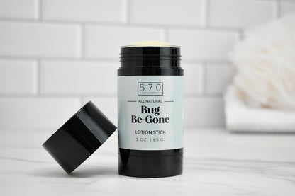 Bug Be-Gone lotion stick with black lid on a white surface