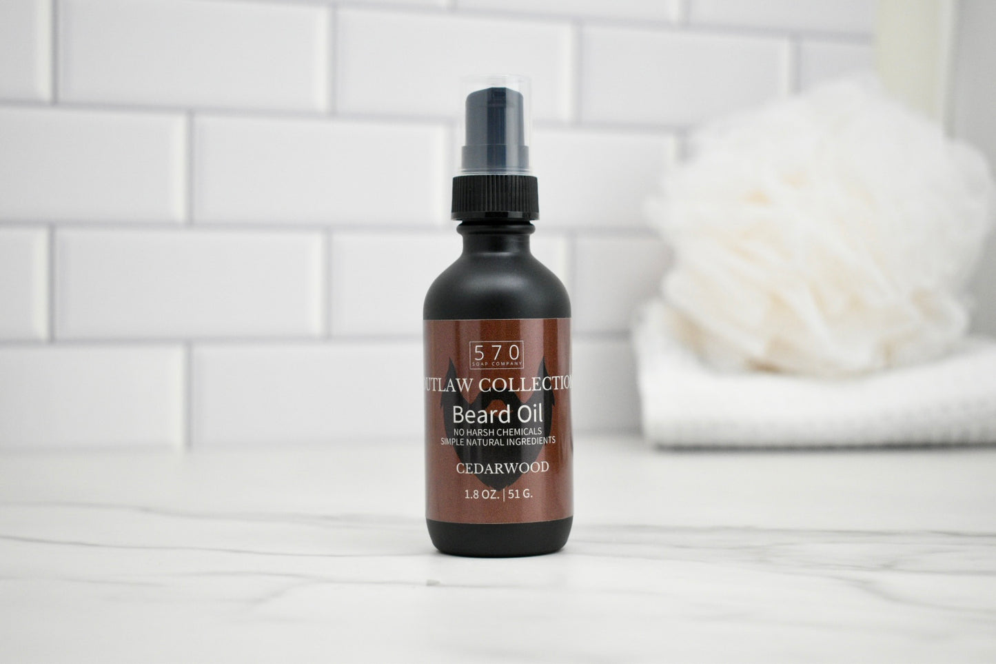 Bottle of 570 Staw Collection Beard Oil on a white tiled surface