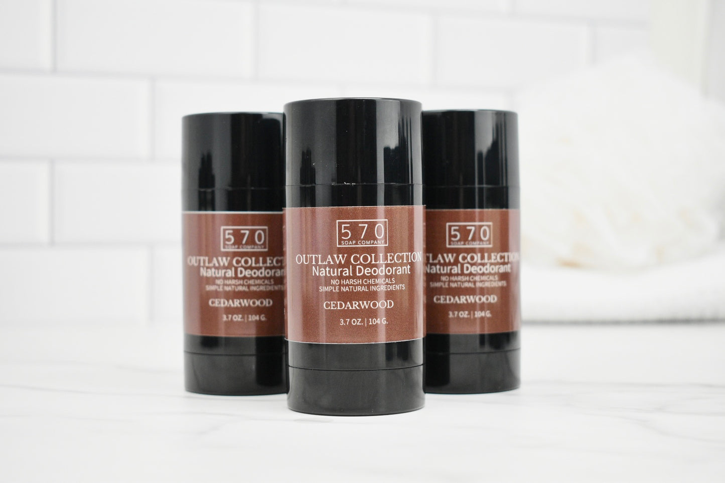 Three deodorant sticks with '570' branding on a white surface.