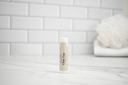 Bottle of Chai Tea on a white surface with a blurred background