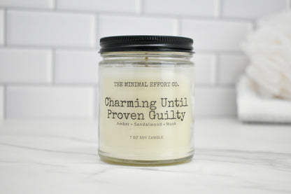 Candle jar with label on a white surface and tiled wall background