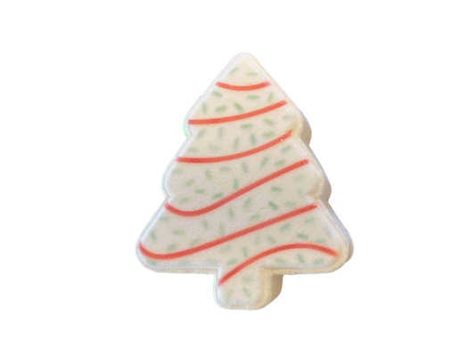 A Christmas tree-shaped bath bomb adorned with red swirl lines, and green dots.